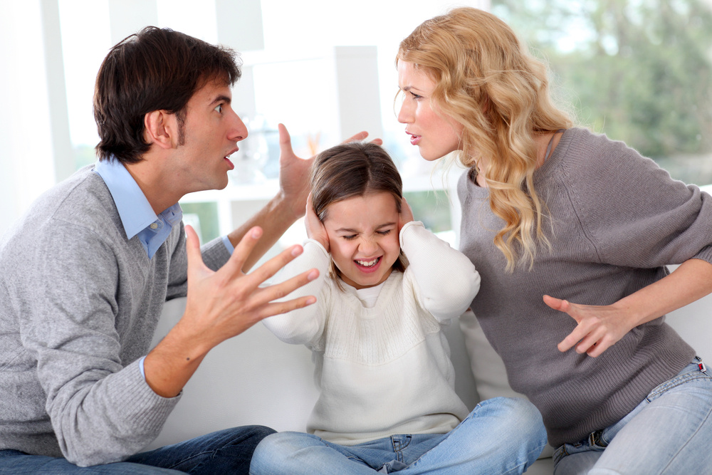 Couple fighting in front of child